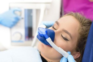 woman with nitrous oxide device over her nose
